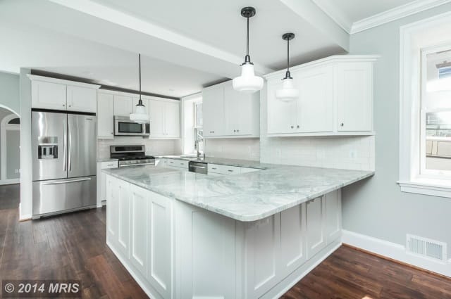All white kitchen with marble counter top