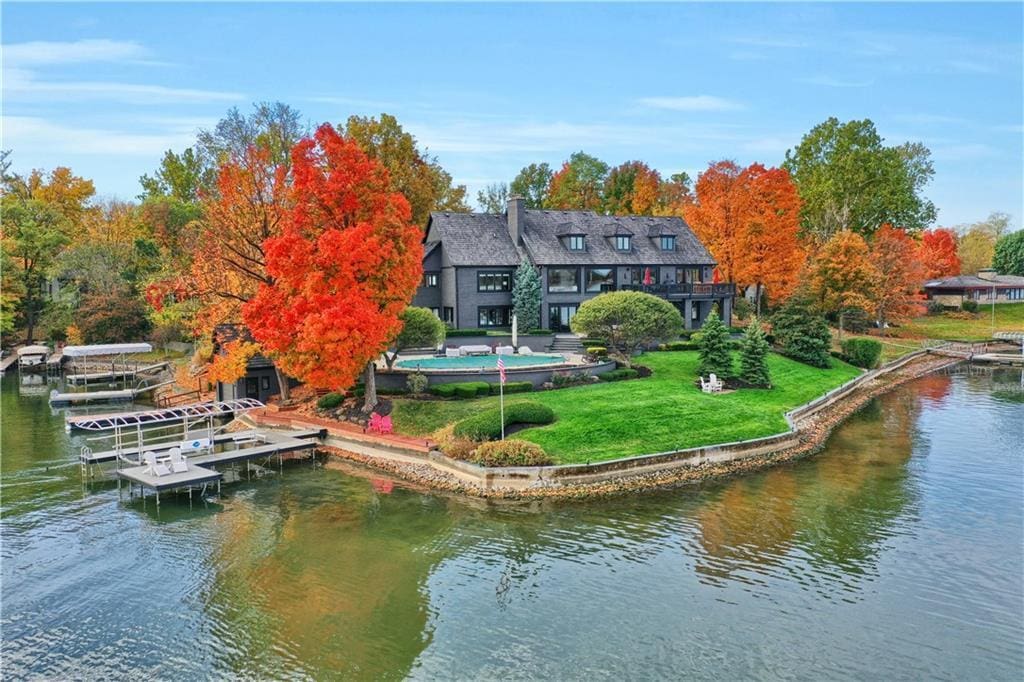 home-on-lake-with-red-trees