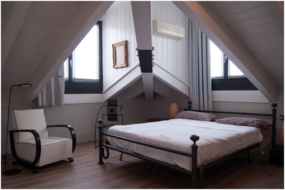 attic bedroom sloped ceiling with two windows