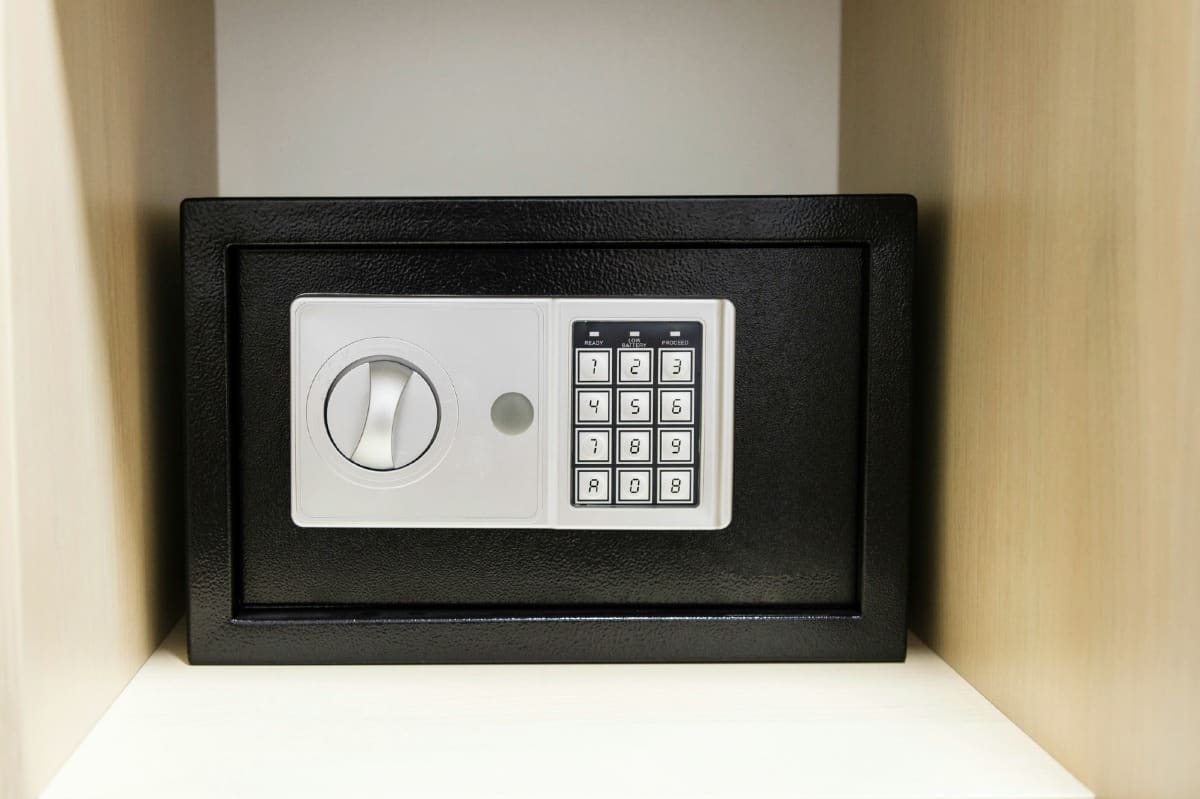 compact safe on shelf of cabinet in hotel room