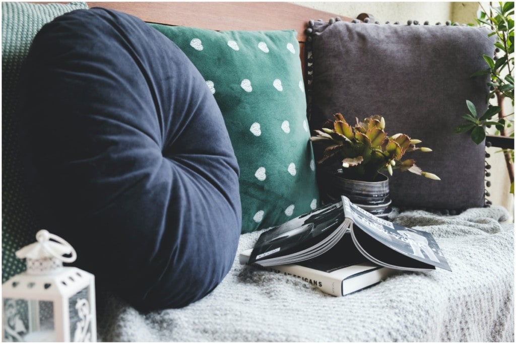 pillows and book in reading nook room makeover