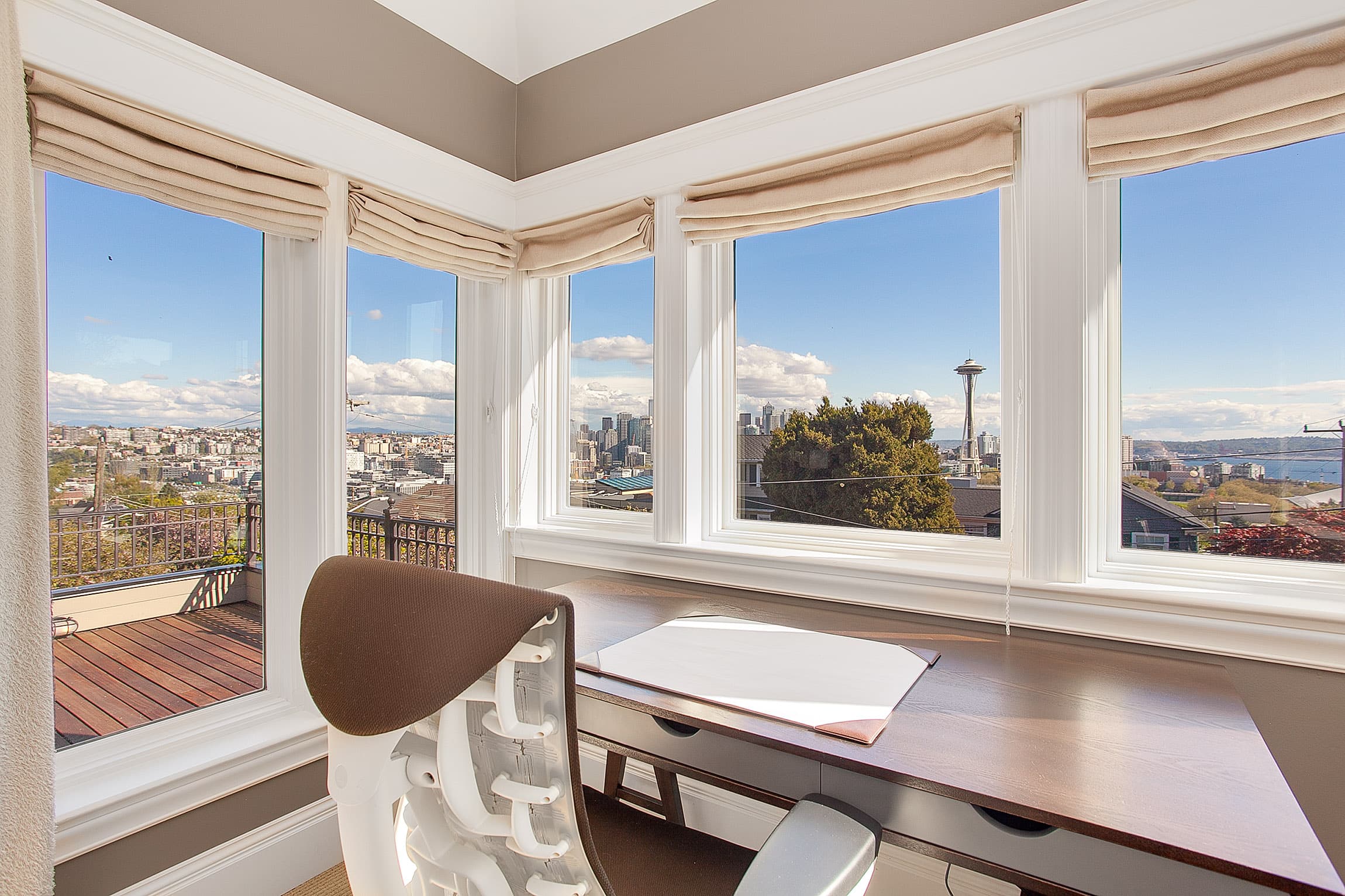 Light office room with contemporary window layout and views of the Space Needle