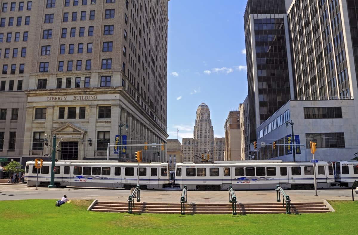 "Buffalo, USA - August 13, 2012: Street view from Buffallo downtown central axis with major office buildings, people and NAFTA-METRO trolley bus."