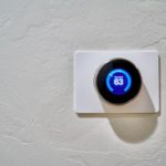 Smart home thermostat on white wall