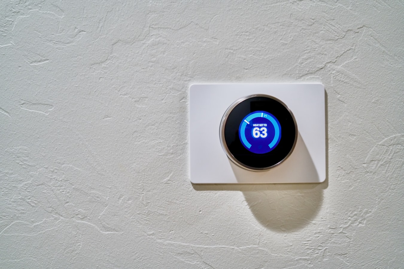 Smart home thermostat on white wall