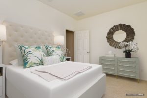 Bedroom with large bed, dresser, and mirror