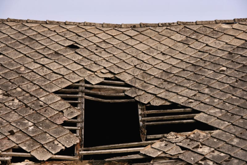 Old collapsed roof on a house after disaster strikes 
