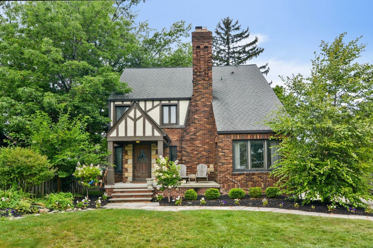 Neutral colored tudor style home with path to the front door