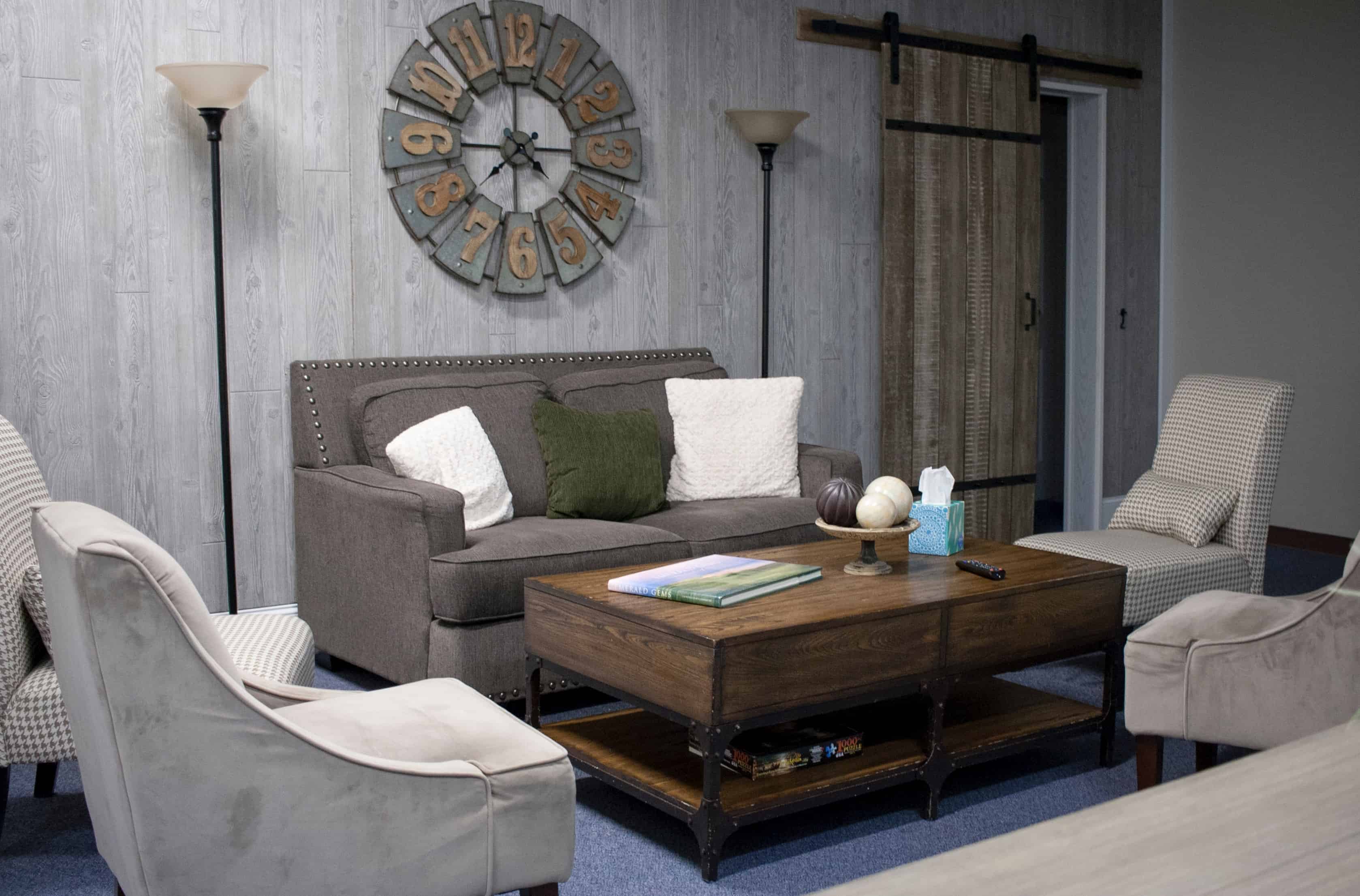 the interior of a home showcasing reclaimed barn wood on the walls and with a barn door