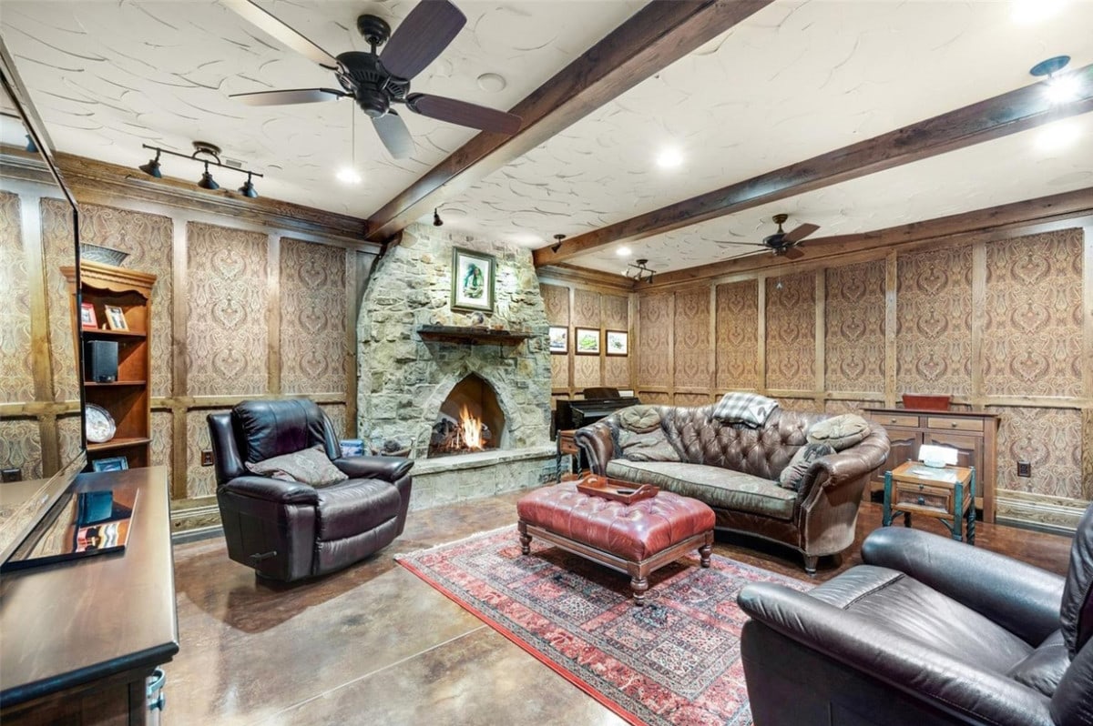 finished basement with furniture and a fireplace