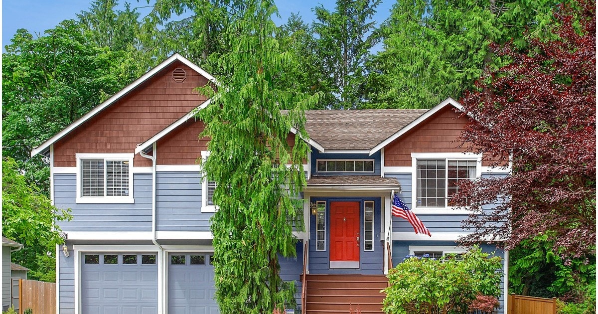 blue house with american flag and red front door