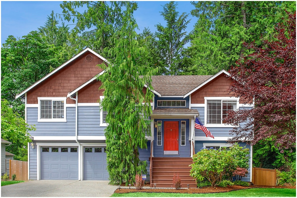 blue house with american flag and red front door