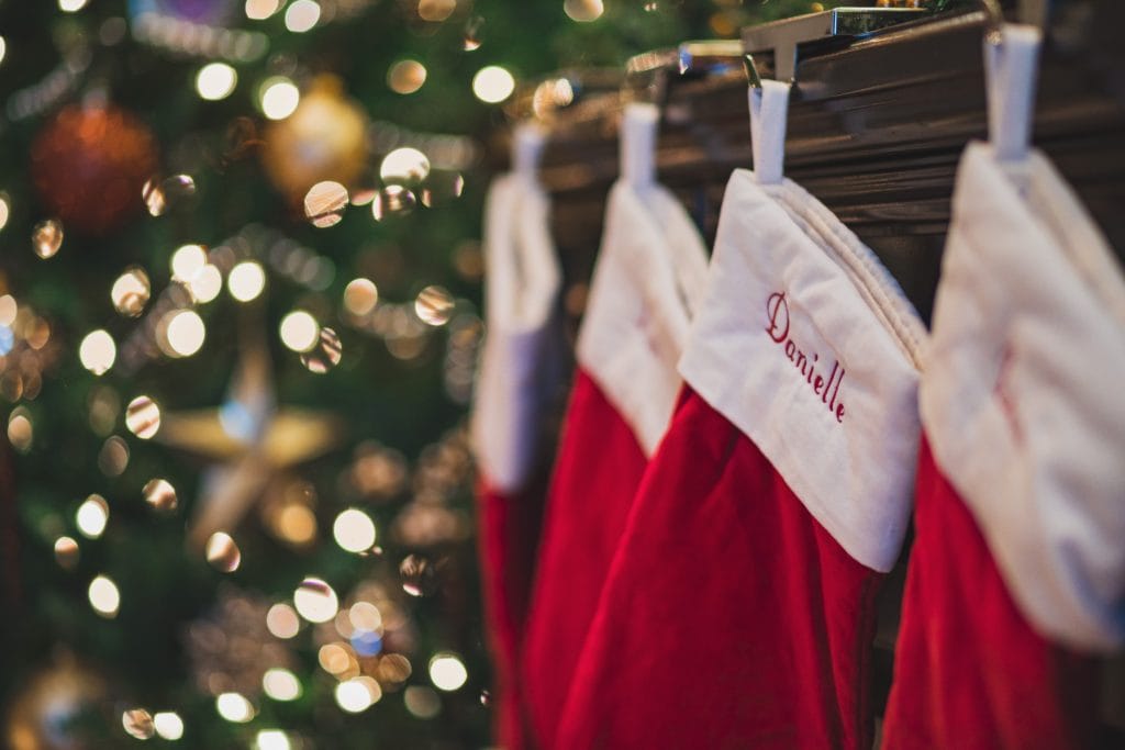 Stockings hung from a mantle that highlights the home feature without covering it