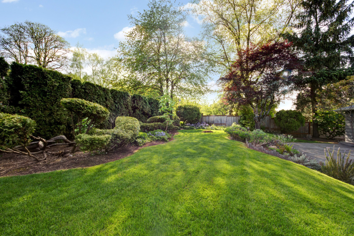 A well-kept yard with trimmed shrubs and freshly mowed grass can increase home value