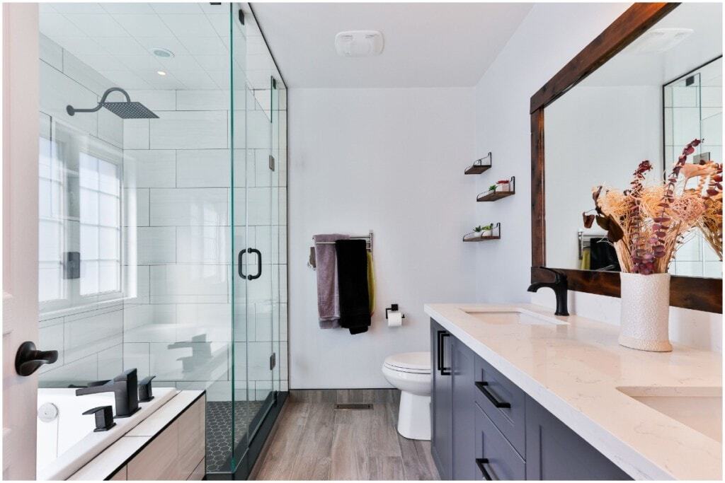 bathroom dark wood mirror and flower arrangement