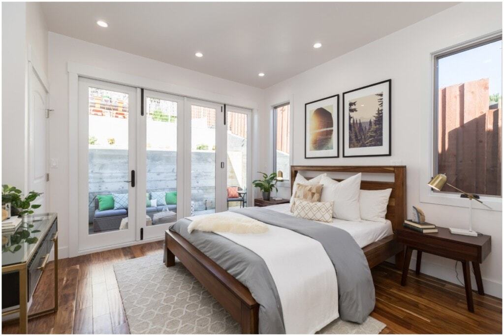 cozy wooden bed frame grey bedding forest photo