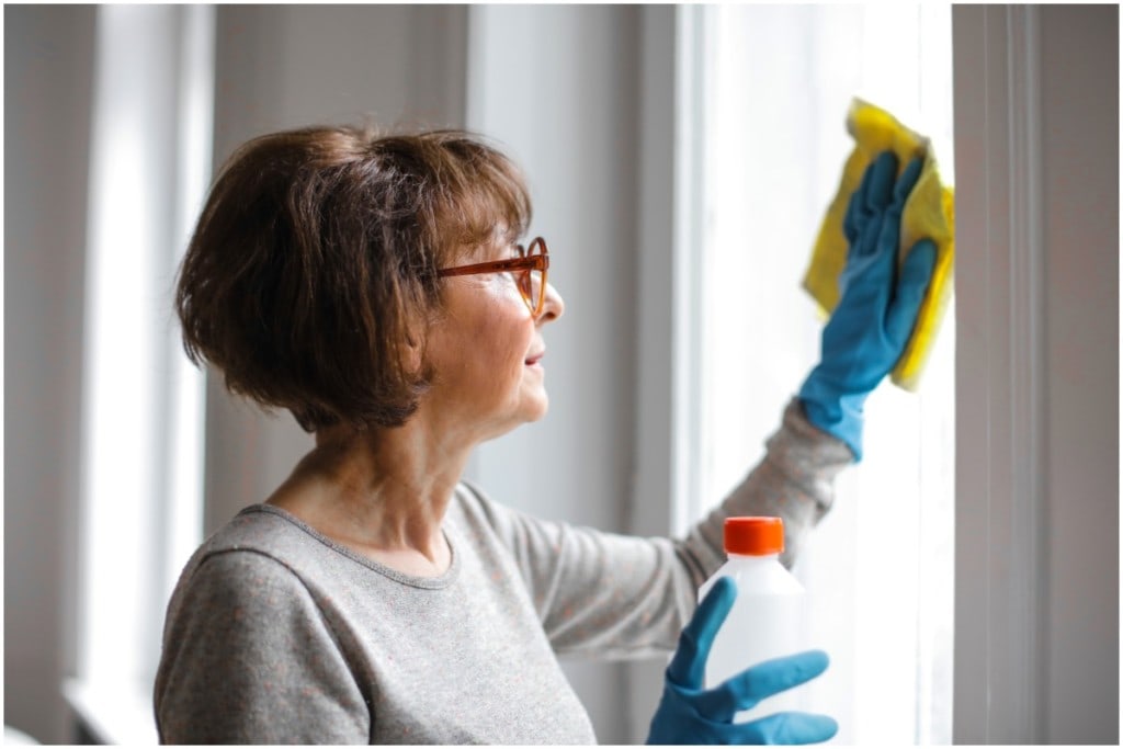woman cleaning windows with homemade cleaner
