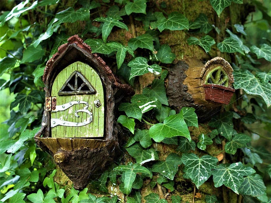 A fairy garden built into a tree is a secret way to enhance your own backyard oasis