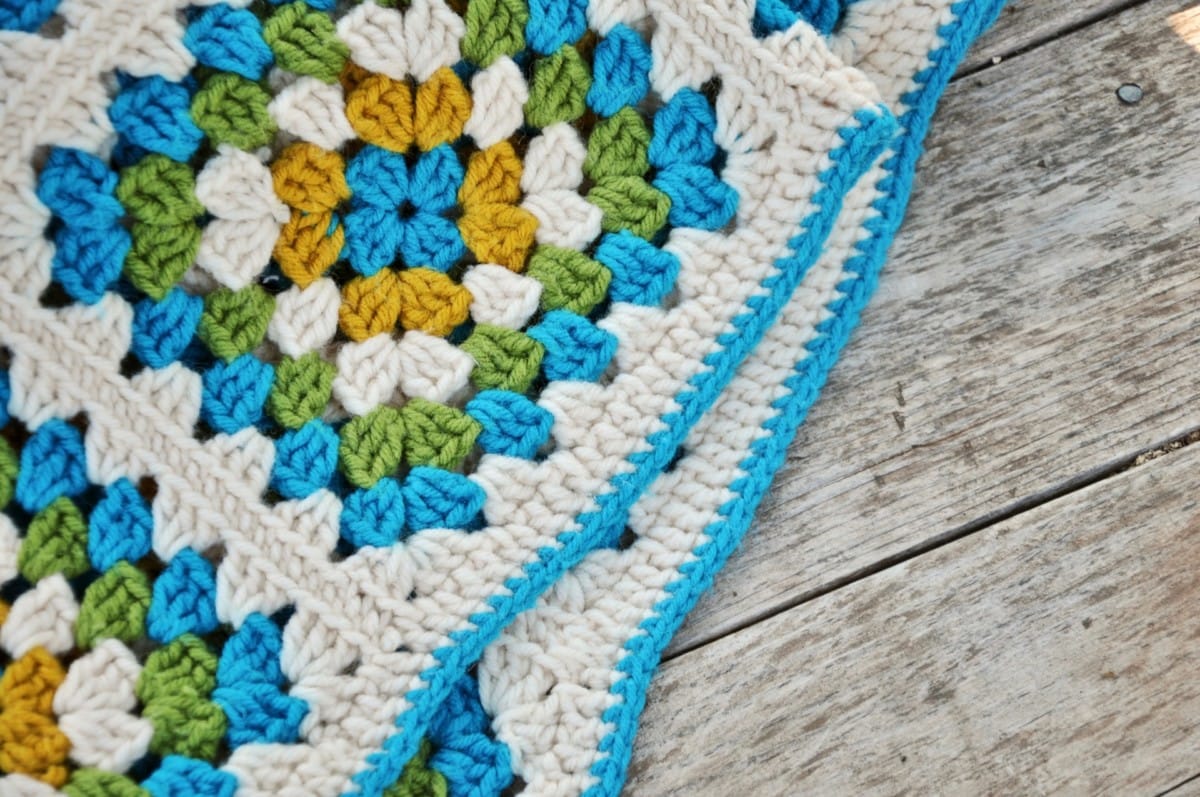 White, blue, green , and orange crocheted piece 