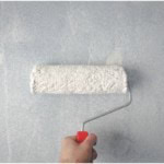 painting white paint on grey wall