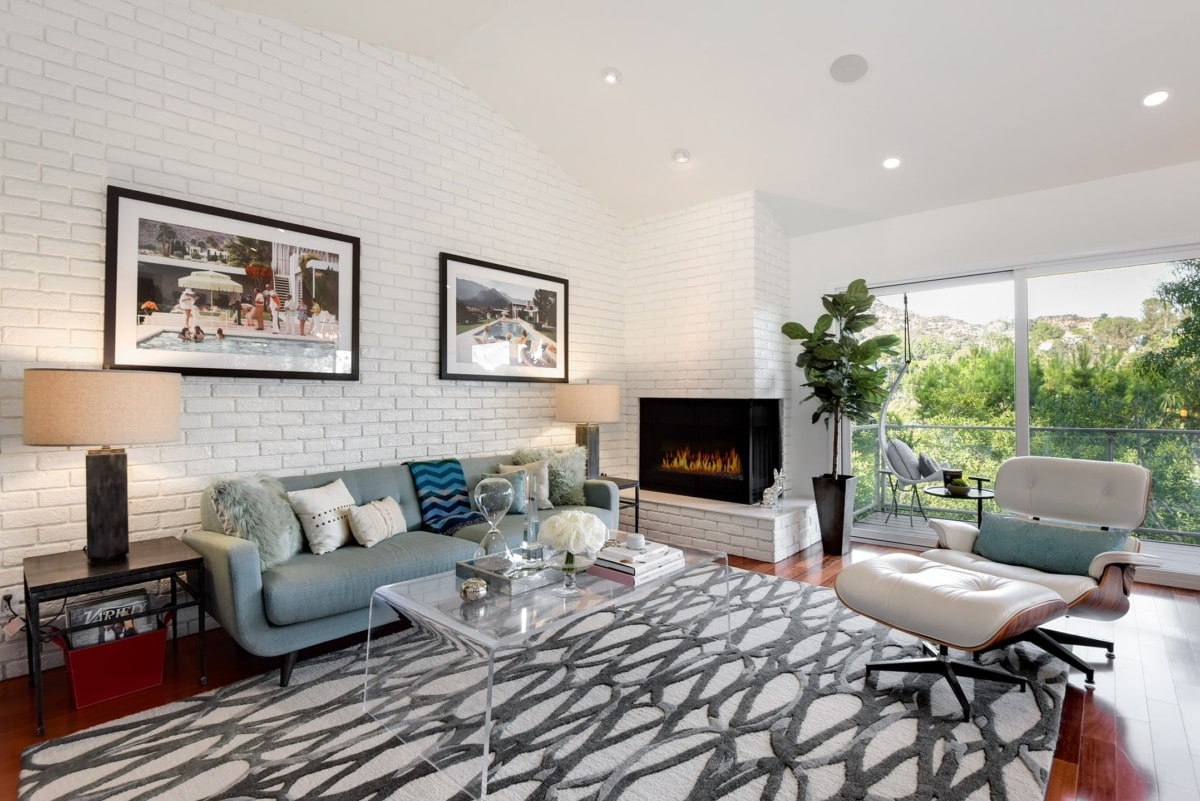 Couch and accent chair in living with fireplace going
