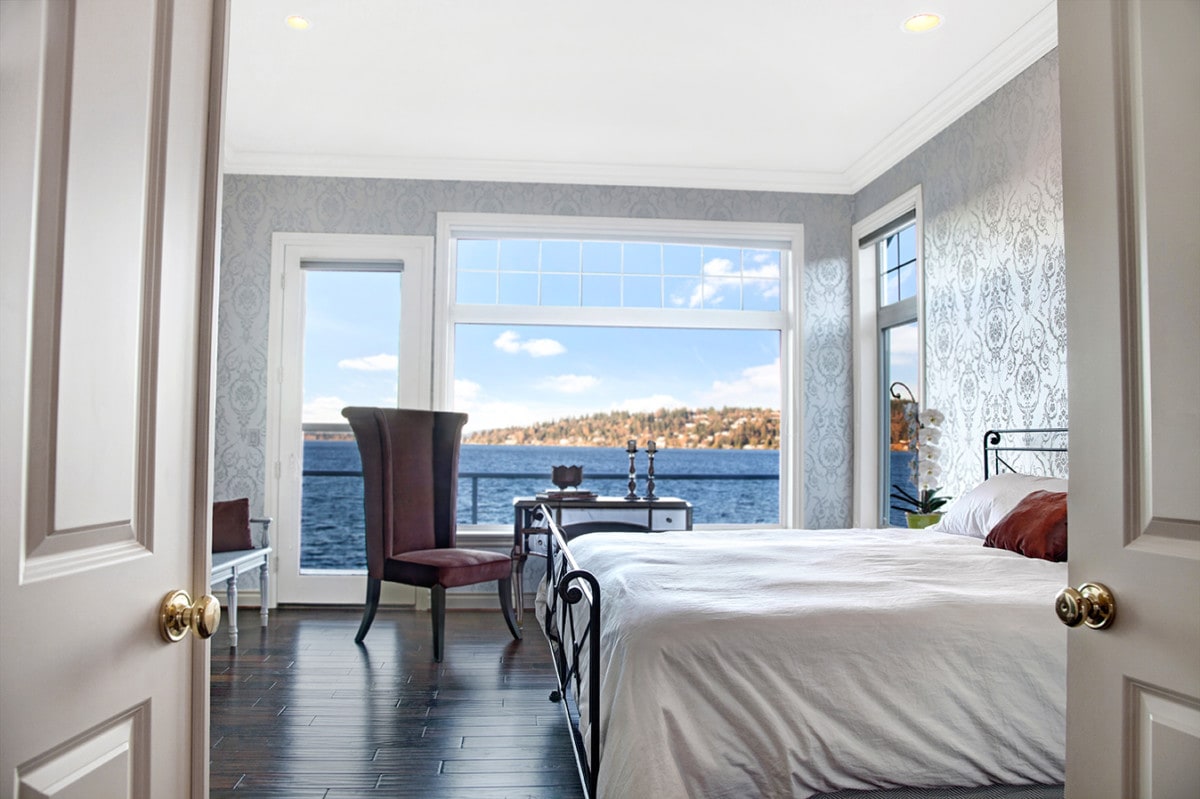 Bedroom with wallpaper and a view of the ocean