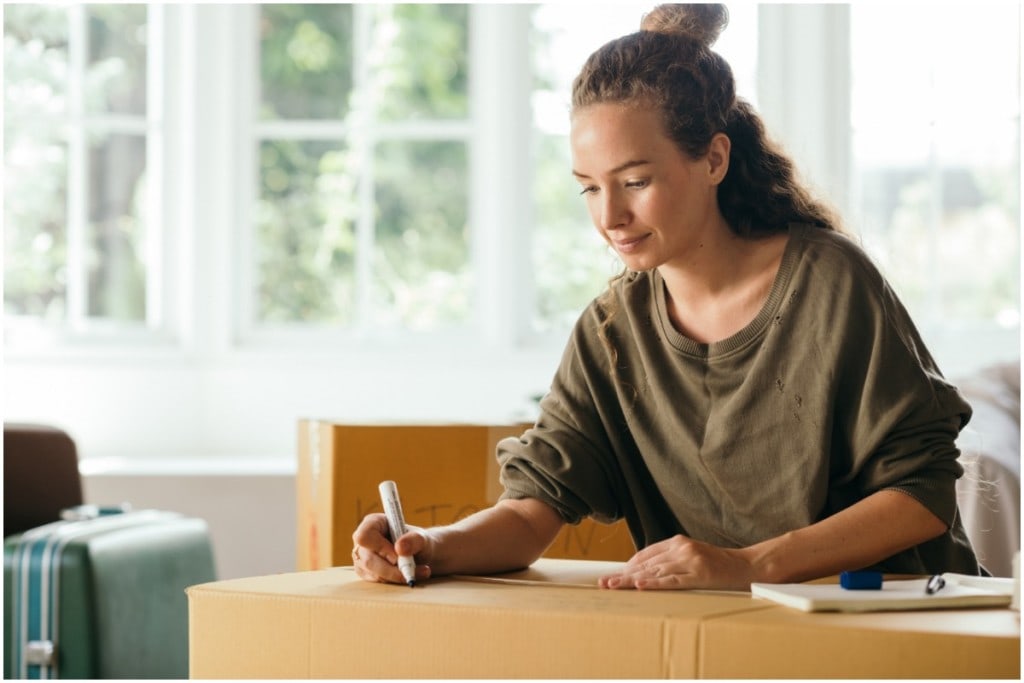 woman packing boxes during moving checklist