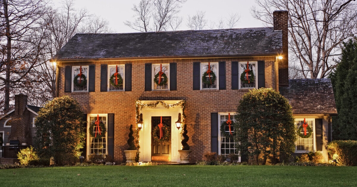 Colonial-style home decorated with christmas lights