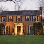 Colonial-style home decorated with christmas lights