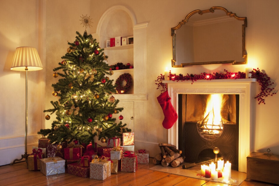 Christmas tree with gifts near fireplace