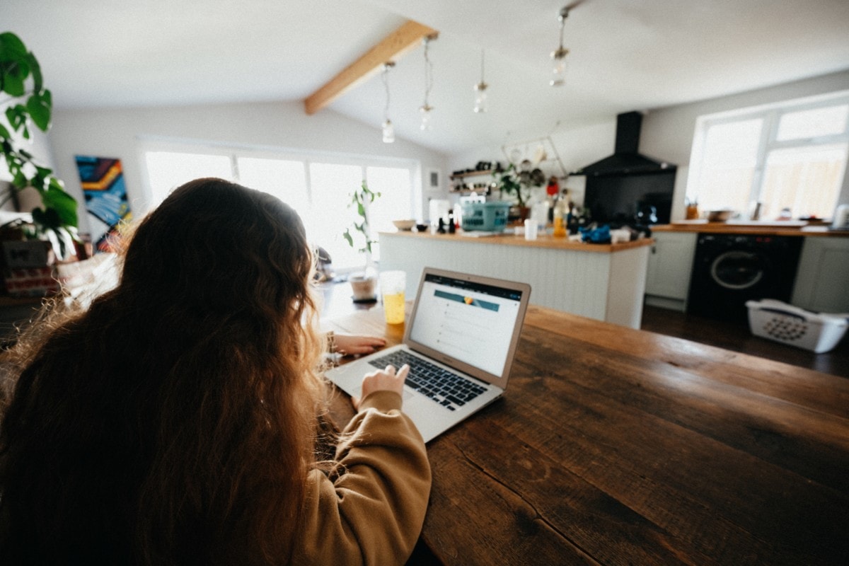 Student attending online classes from her dining table at home