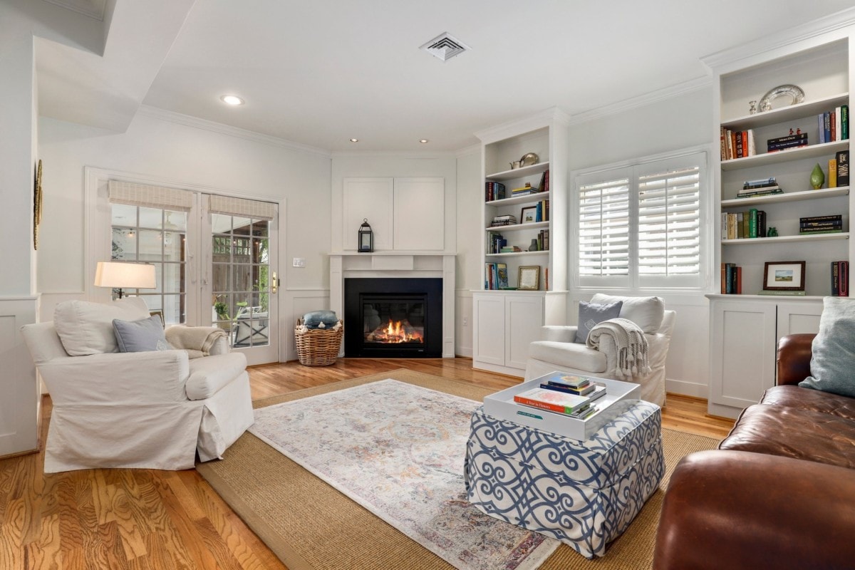Organized living room with hardwood floors and a fireplace