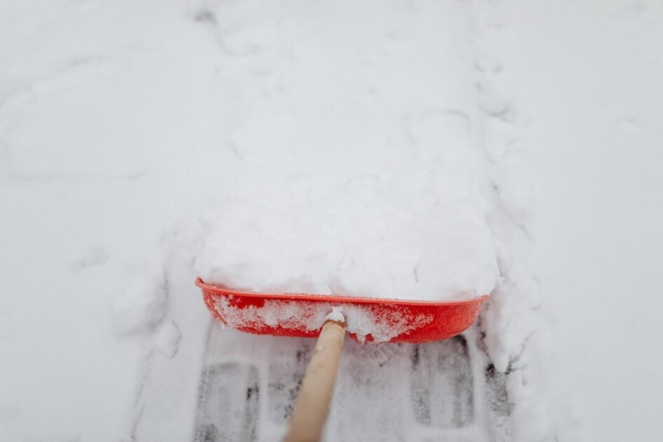 Red shovel for shoveling snow when selling your home during the holidays