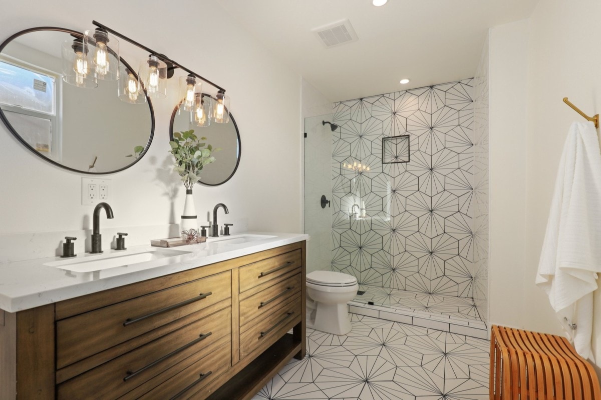 designer bathroom wood cabinetry circle mirrors
