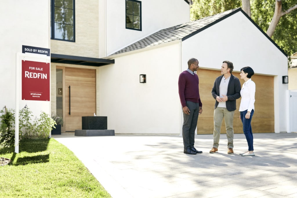 An agent discussing with a couple great real estate tips to consider to help them sell their home.