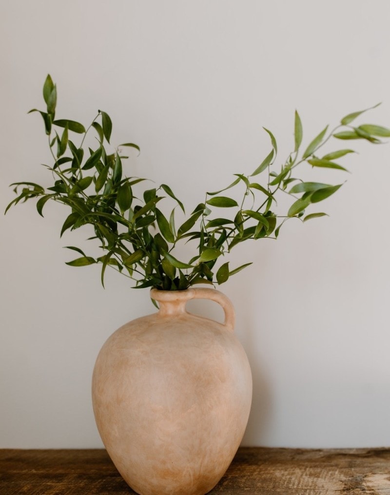 Decorative pottery displayed with greenery