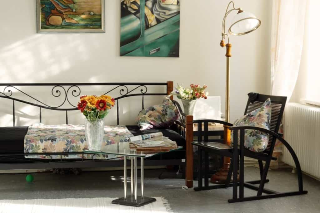 black wicker chair floral pillows