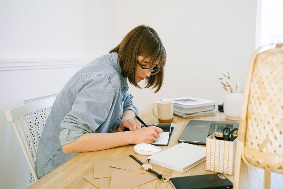 A woman working from a desk at home