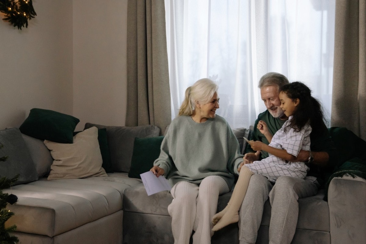 A man and woman with their granddaughter after deciding that now is the right time to downsize their home