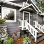 A gray house with a storm door