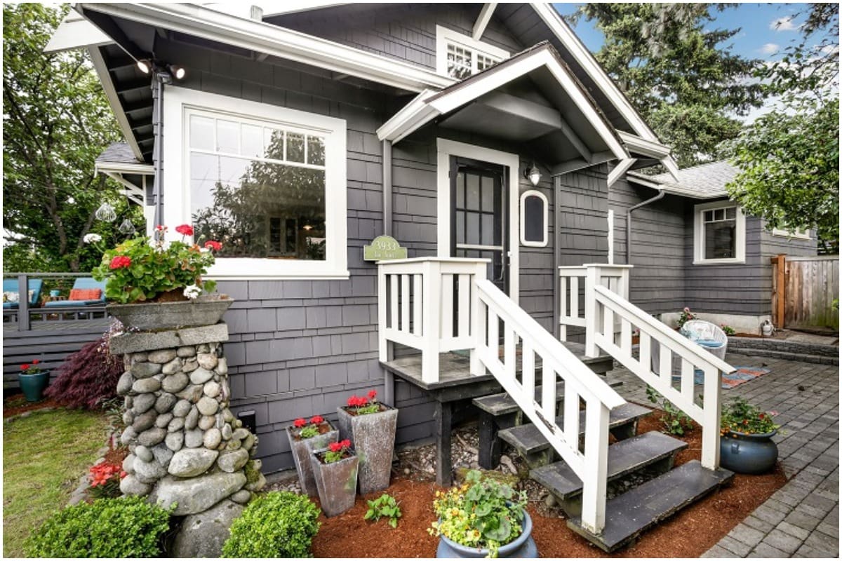 A gray house with a storm door