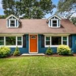 blue-house-front-yard-with-white-trim-orange-door