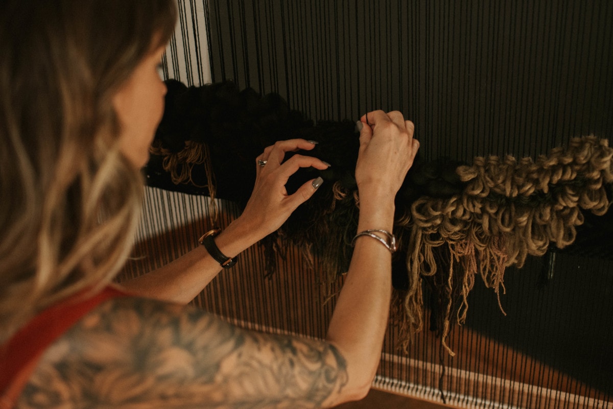 woven-artwork-with-woman-threading
