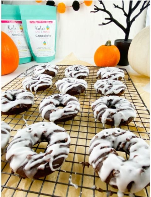 Healthy chocolate donuts with a pumpkin twist and mummy-like frosting drizzle
