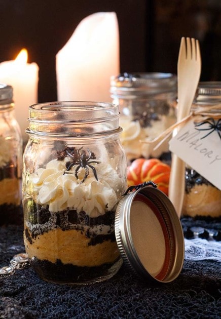 Festive Halloween-themed pumpkin cheesecake in a jar