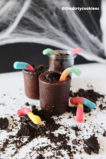 Graveyard cookie shot filled with chocolate, oreo, and gummy worms