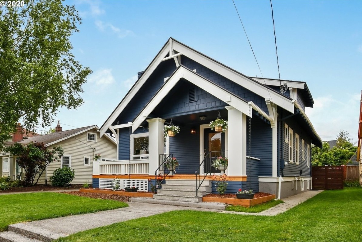 blue craftsman style home big front porch