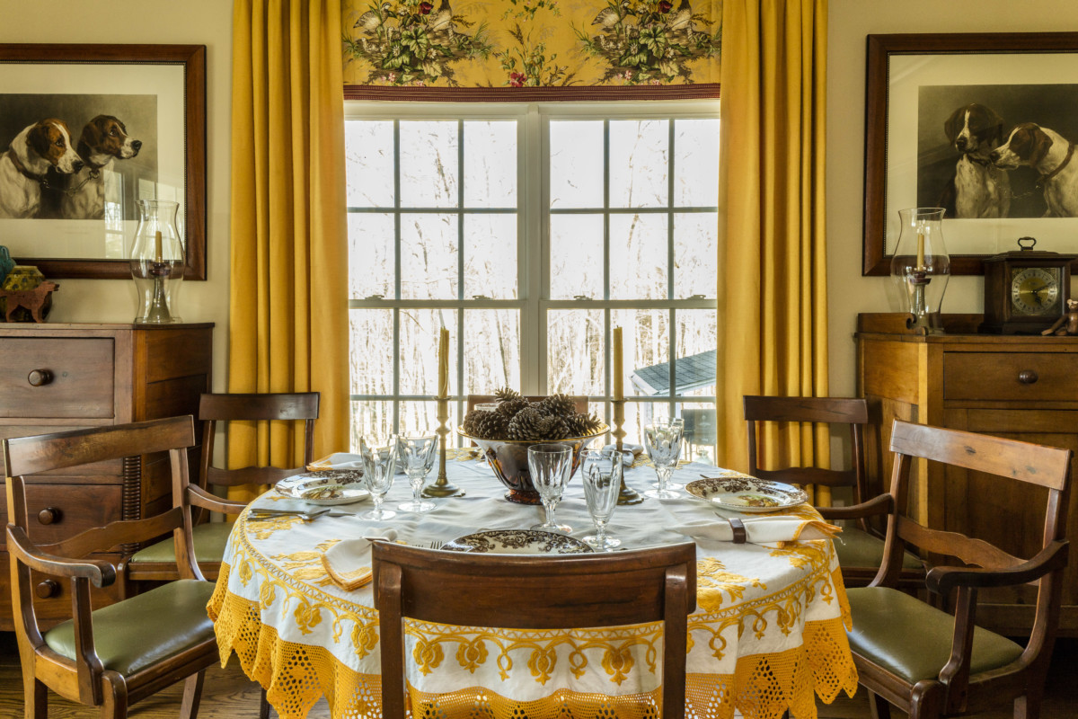 yellow dining room with candles and table settings