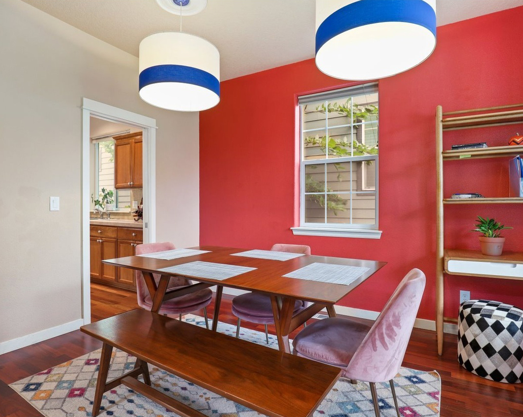 dining room with a coral red accent wall