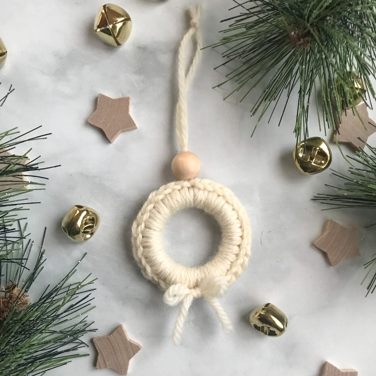 mini wreath ornament with stars around it on a white background